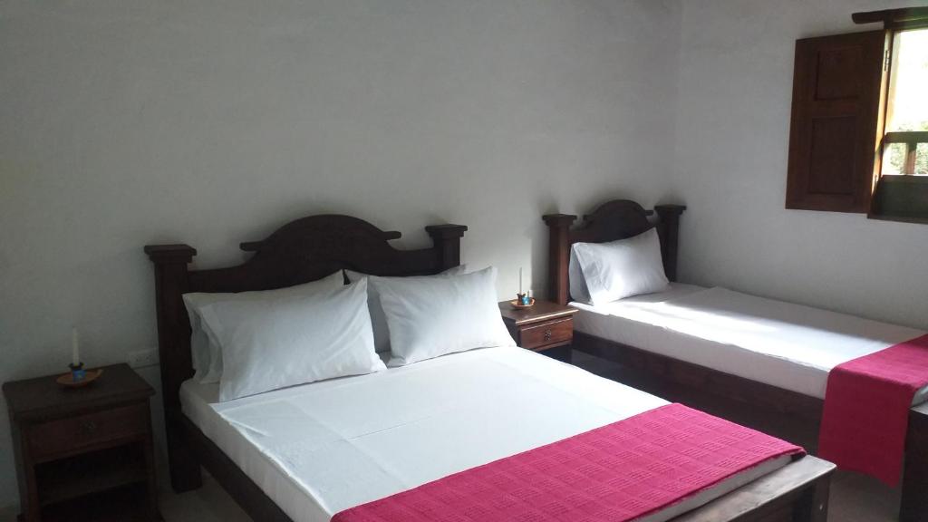 Postel nebo postele na pokoji v ubytování Posada Villa Paula