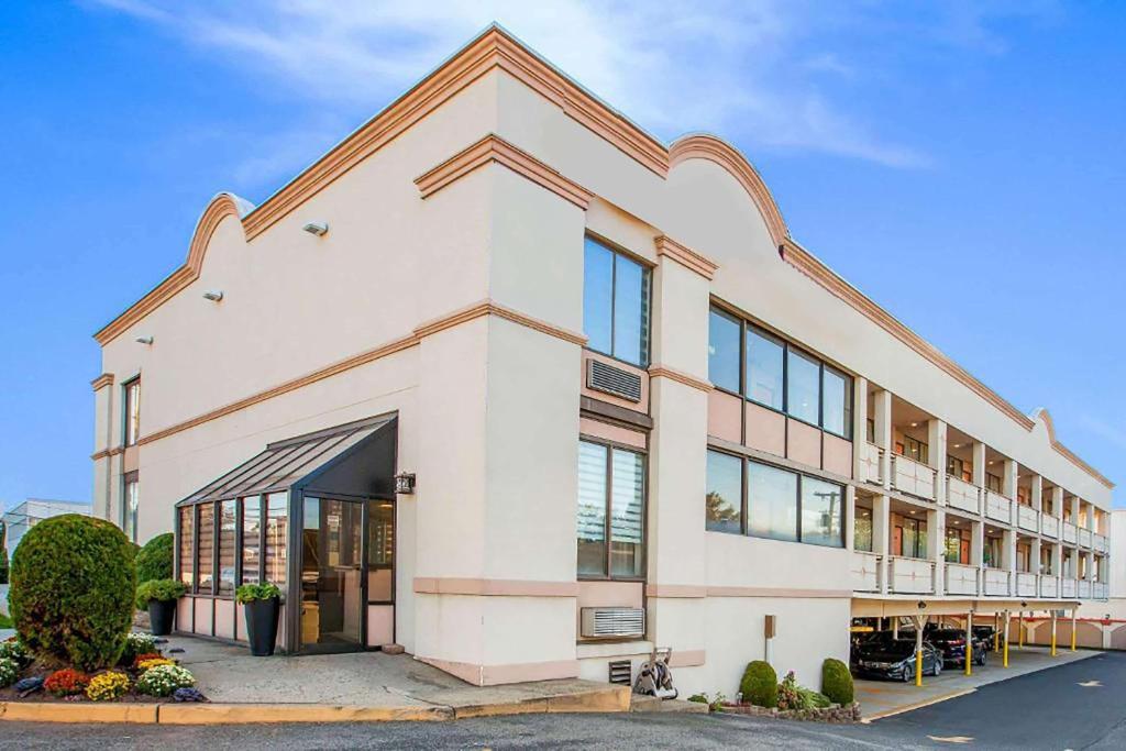 a large white building with a lot of windows at Super 8 by Wyndham Meadowlands in Carlstadt