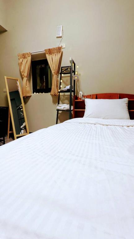 Postel nebo postele na pokoji v ubytování 高鐵背包客 HSR BnB 桃園民宿 063號