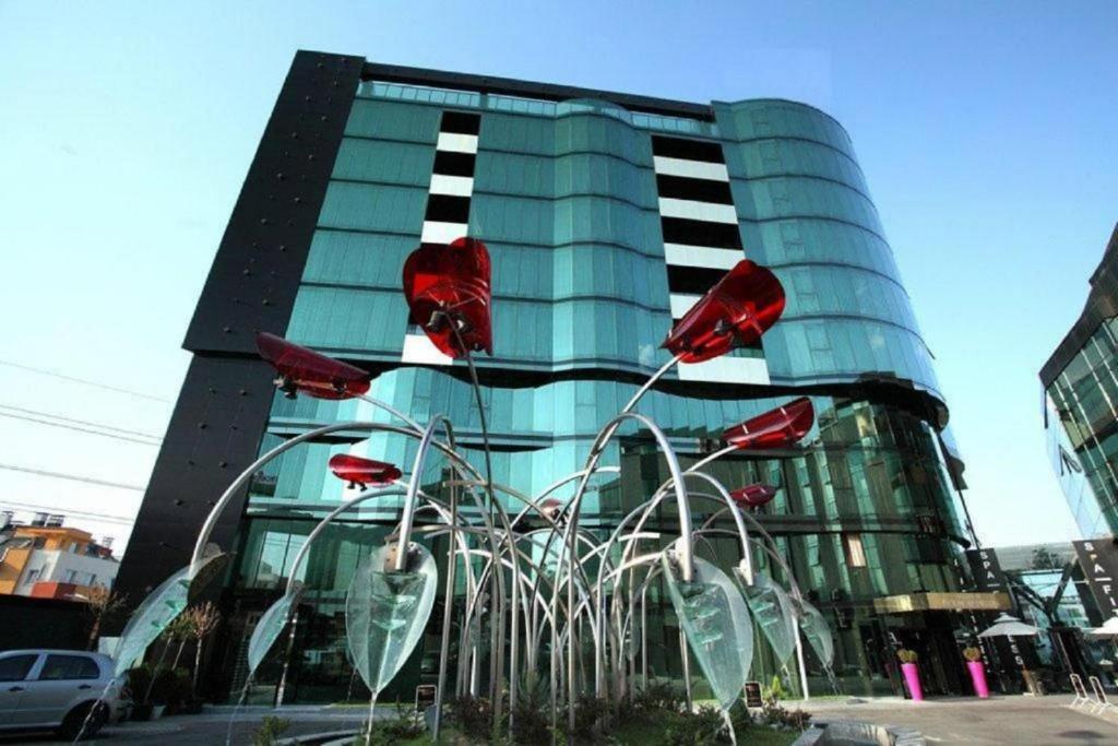 a building with a fountain in front of a building at Hotel Emirates in Sofia