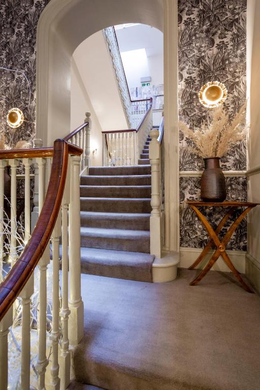 a staircase in a home with a stair case at The Queensberry Hotel in Bath