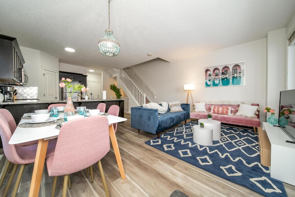 a living room with a table and chairs and a couch at Mediterranean Retreat - King Bed - Fireplace - Jacuzzi - Fast Wi-Fi - Games Room - Free Parking & Netflix in Edmonton