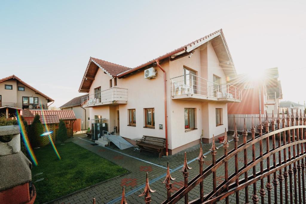 a house with a fence in front of it at Pensiunea Alin in Turda