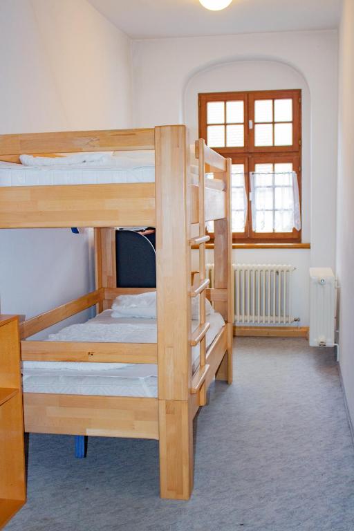 Postel nebo postele na pokoji v ubytování CVJM Peregrinus Herberge