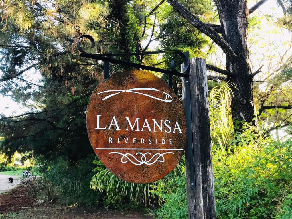 a sign that says la manneska refugee at La Mansa Riverside in Esquina