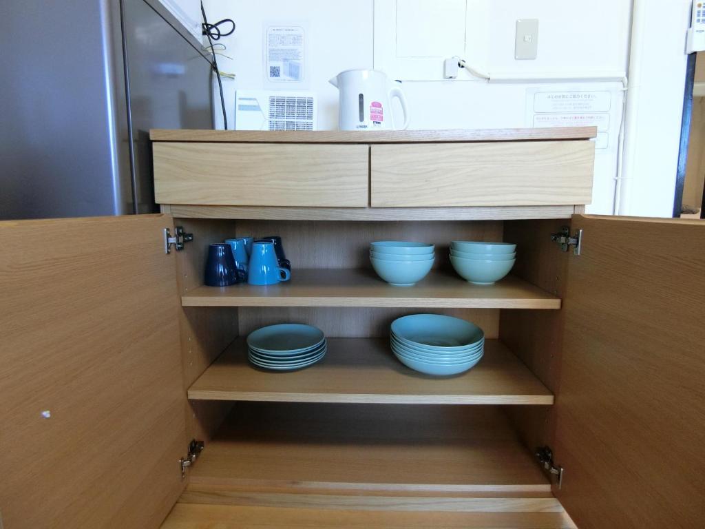 Kuchyň nebo kuchyňský kout v ubytování Simple Stay Beppu