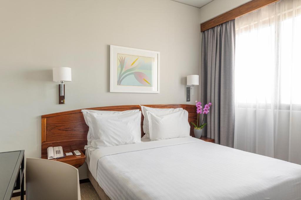 Postel nebo postele na pokoji v ubytování Hotel Dom Carlos Park