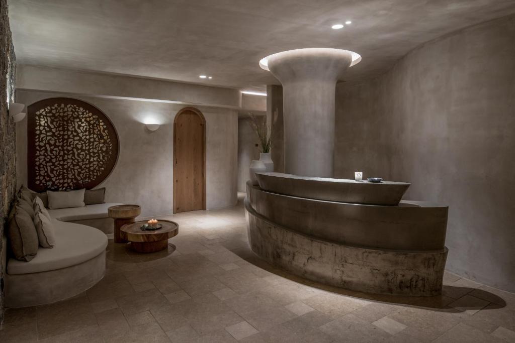 a bathroom with a large tub in a room at Acro Suites - A Wellbeing Resort in Agia Pelagia