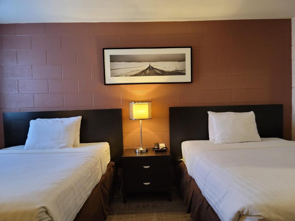 Ένα ή περισσότερα κρεβάτια σε δωμάτιο στο Roadking Inns Motel