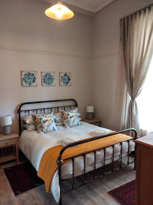a bedroom with a bed and a window at Via the Grapevine 3 bedroom house private parking in Colesberg