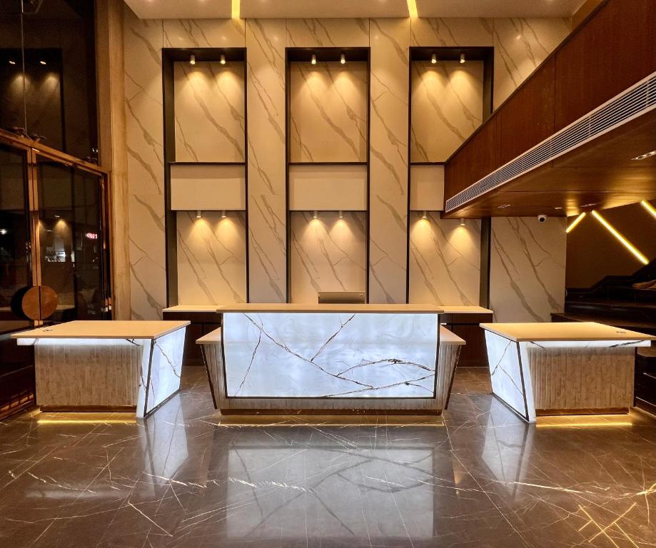 a lobby with a table and two stools at The Prime Delhi in New Delhi