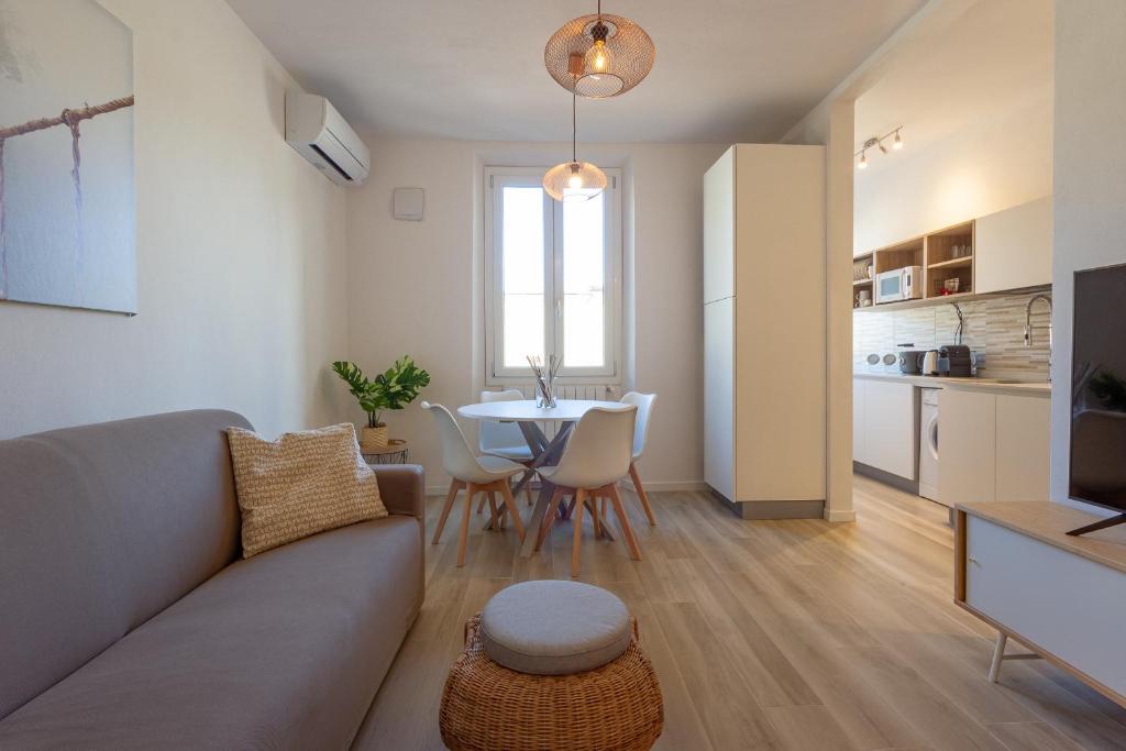 a living room with a couch and a table at Mosse Leopolda Apartment by Mamo Florence in Florence