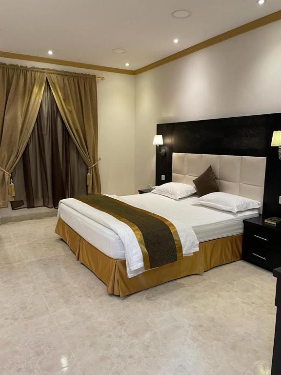 Postel nebo postele na pokoji v ubytování روح الأصيلة للشقق المخدومة Roh Alaseilah Serviced Apartments