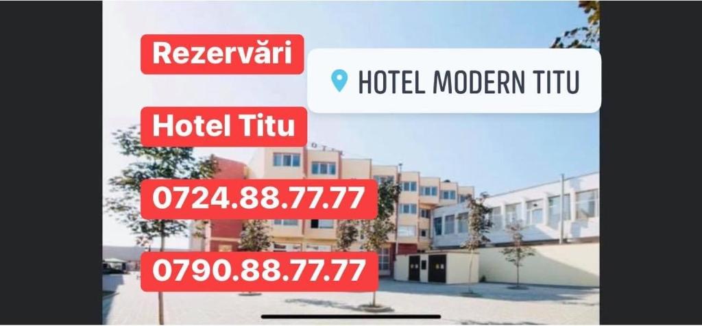 un letrero de la calle frente a un edificio en HOTEL modern / Imobiliare Garcea Titu en Titu