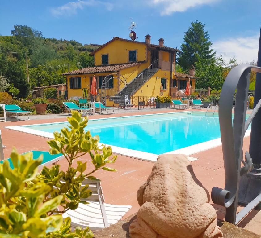 a house and a swimming pool with a house in the background at Casa Elisa in Montaione