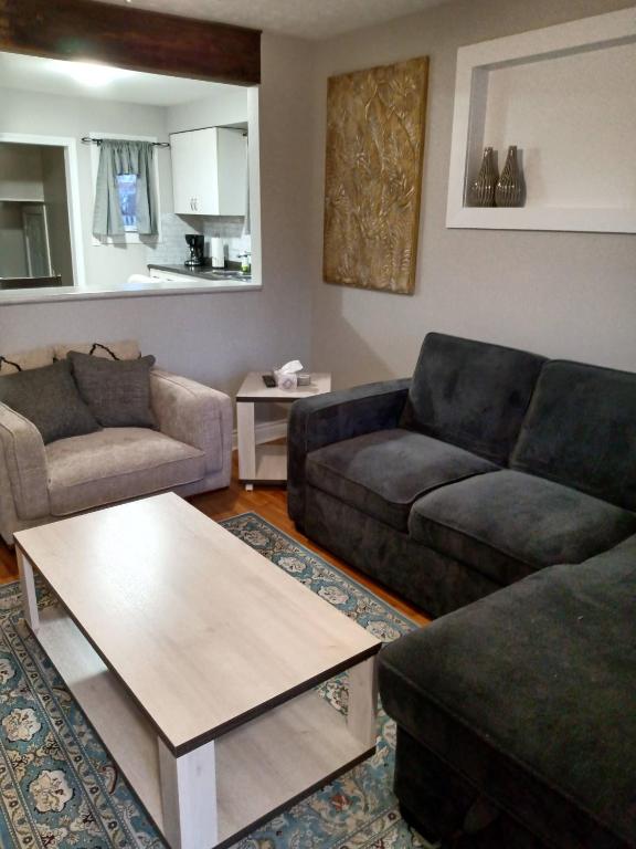 a living room with two couches and a coffee table at Toronto Furnished Living- Niagara Falls in Niagara Falls