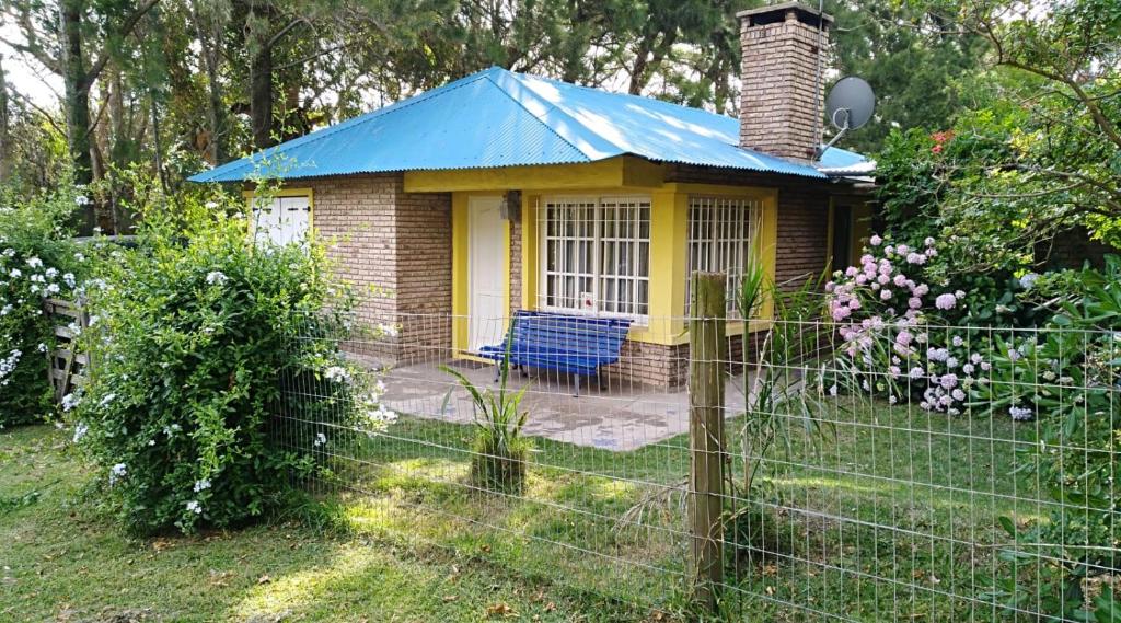 une petite maison jaune et bleue dans une cour dans l'établissement Casa Azul, à Maldonado