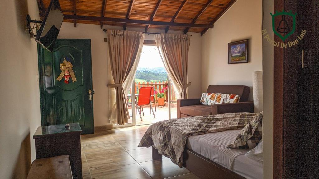 a bedroom with a bed and a view of a balcony at El Portal De Don Luis in Guadalupe