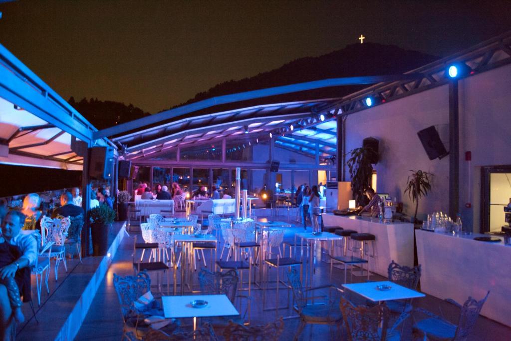 a restaurant with tables and chairs at night at Lingos Hotel in Florina