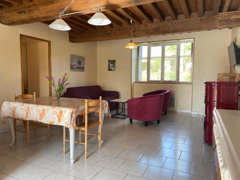 a living room with a table and chairs at Gîte du Morvan in Saint-Germain-des-Champs