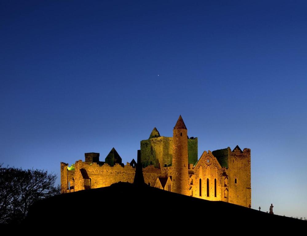 a castle at night with a blue sky at 3 BEDROOM LUXURY APARTMENT Across the street from THE CASHEL PALACE HOTEL in Cashel