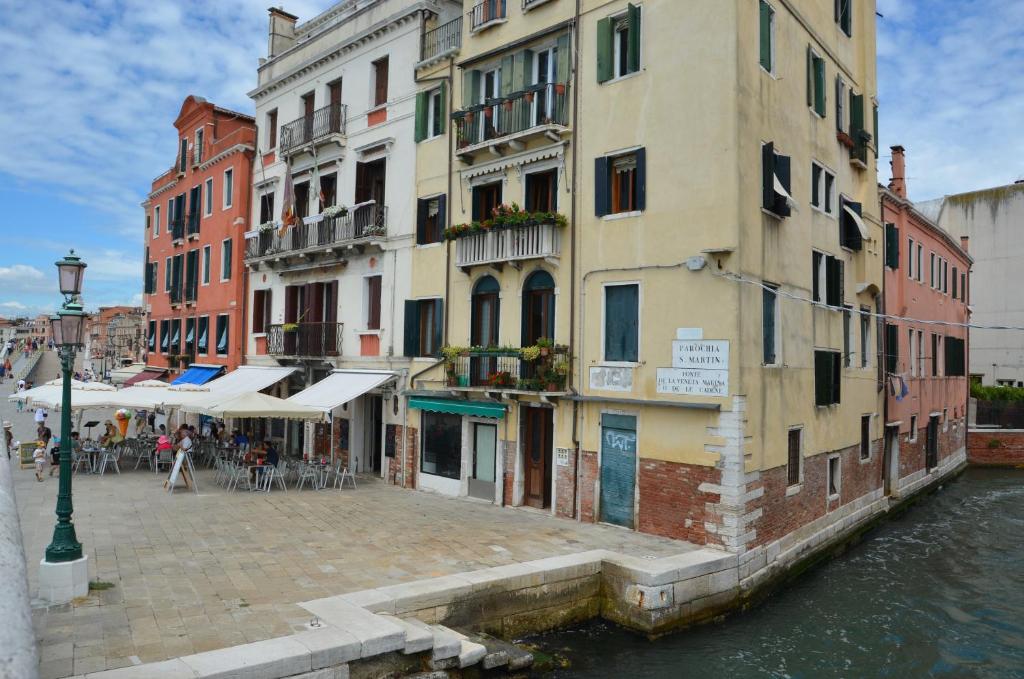 a group of buildings next to a canal at Casa Favaretto Guest House in Venice