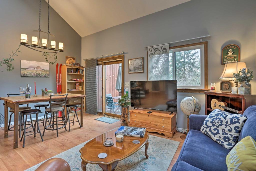 a living room with a blue couch and a table at Pet-Friendly Townhome with Community Hot Tub! in Vernon Township