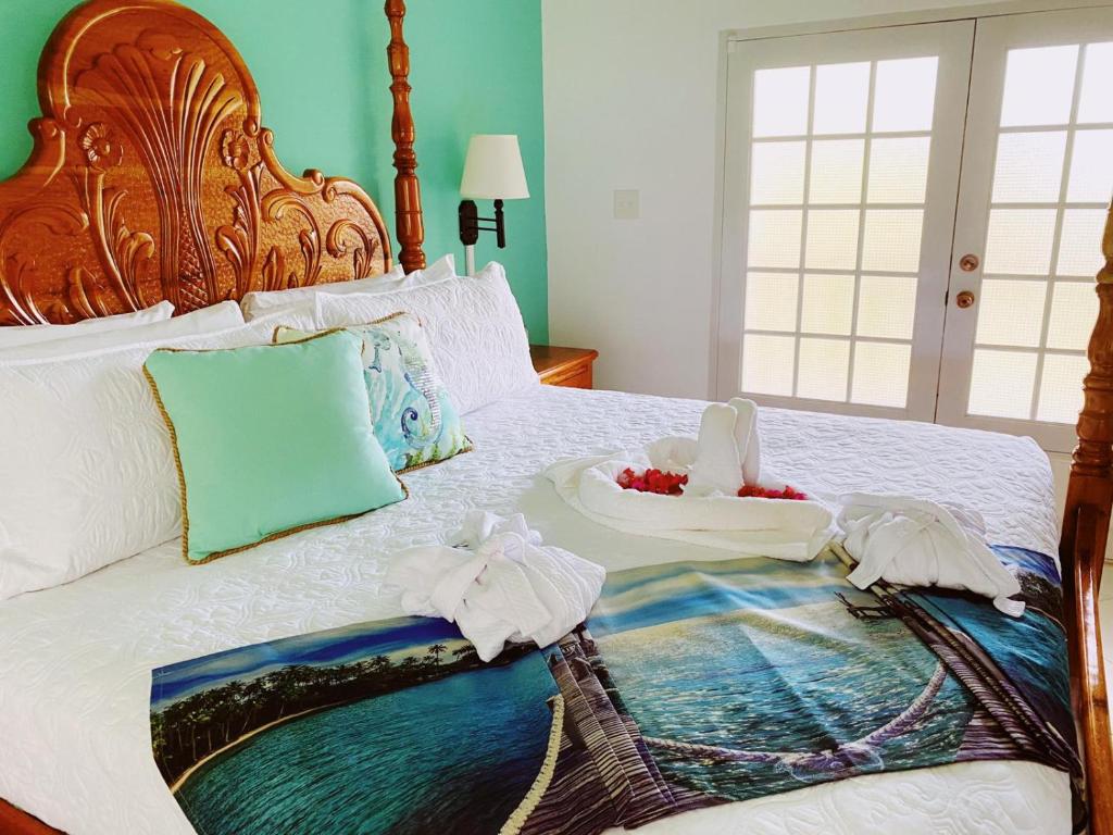 a bed with towels and a tray of food on it at Sommerville Resorts in Negril