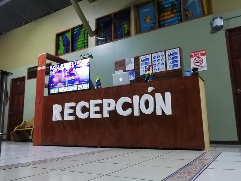 a reception desk in a building with a laptop on it at Sleeping Mountain Arenal in Fortuna
