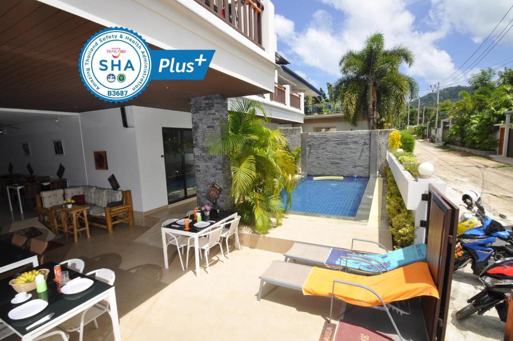 a villa with a swimming pool and a restaurant at Duangjai Residence - SHA Extra Plus in Rawai Beach