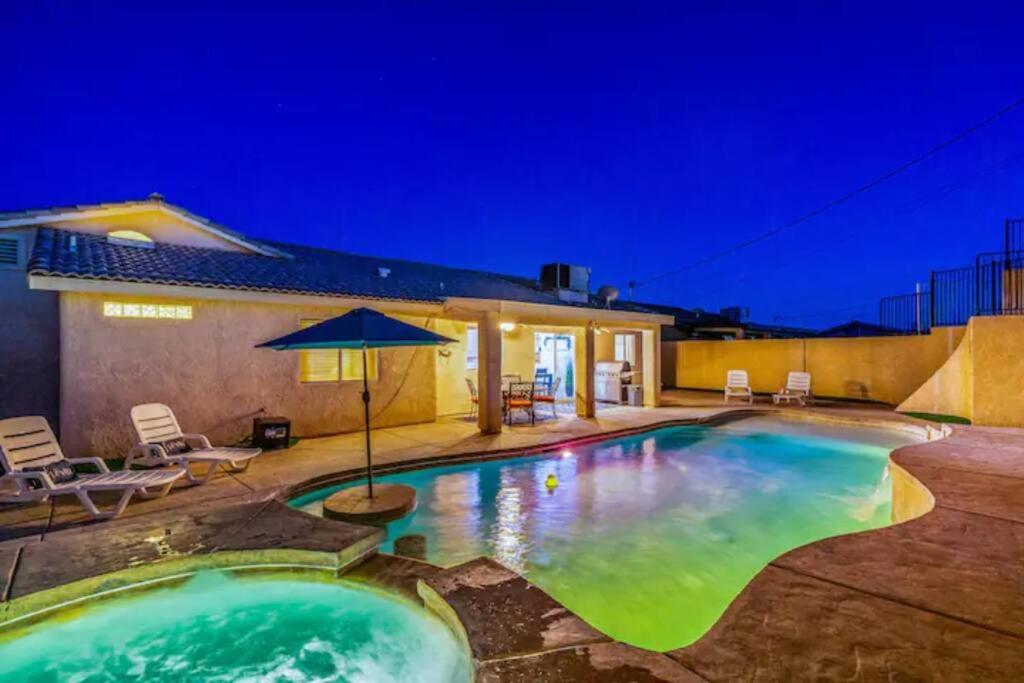 a swimming pool in a backyard at night at Playpool Oasis-Pool, Spa, Garage, Great Lake Views in Lake Havasu City