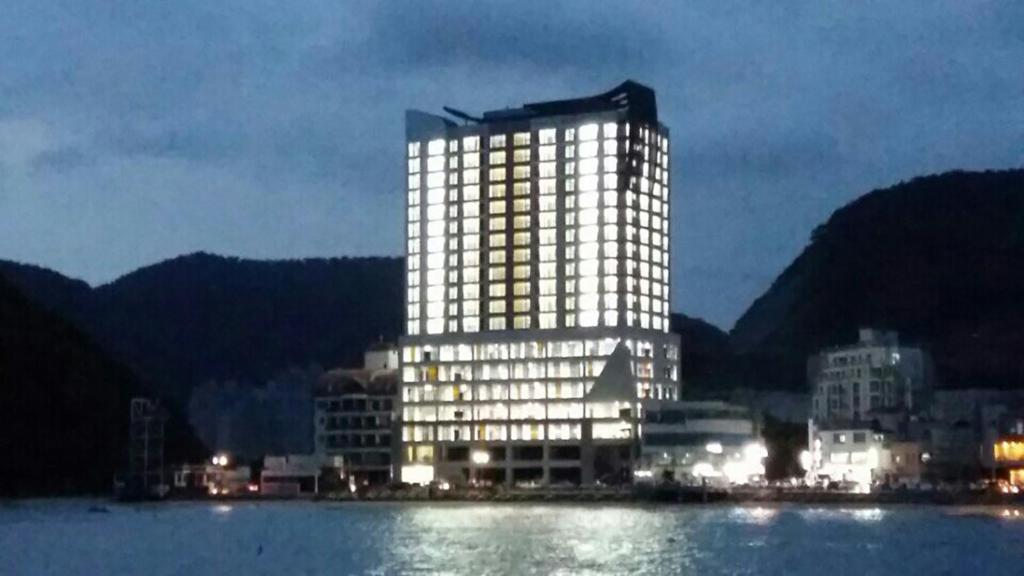 a lit up building in the middle of the water at Ocean View in Geoje 