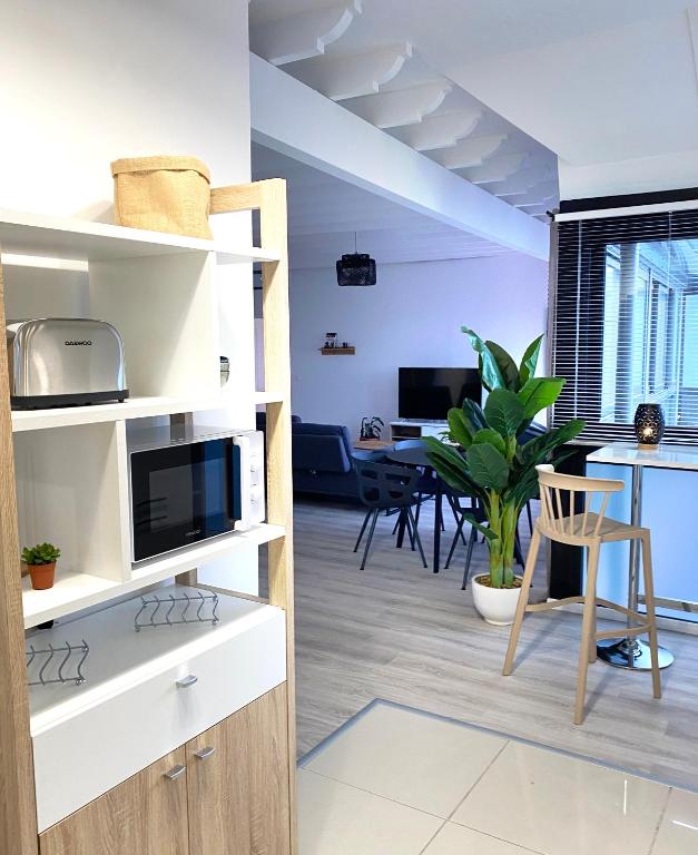 a living room with a loft bed and a dining room at Sélina by Les Suites d&#39;Alfred in Saint-Denis