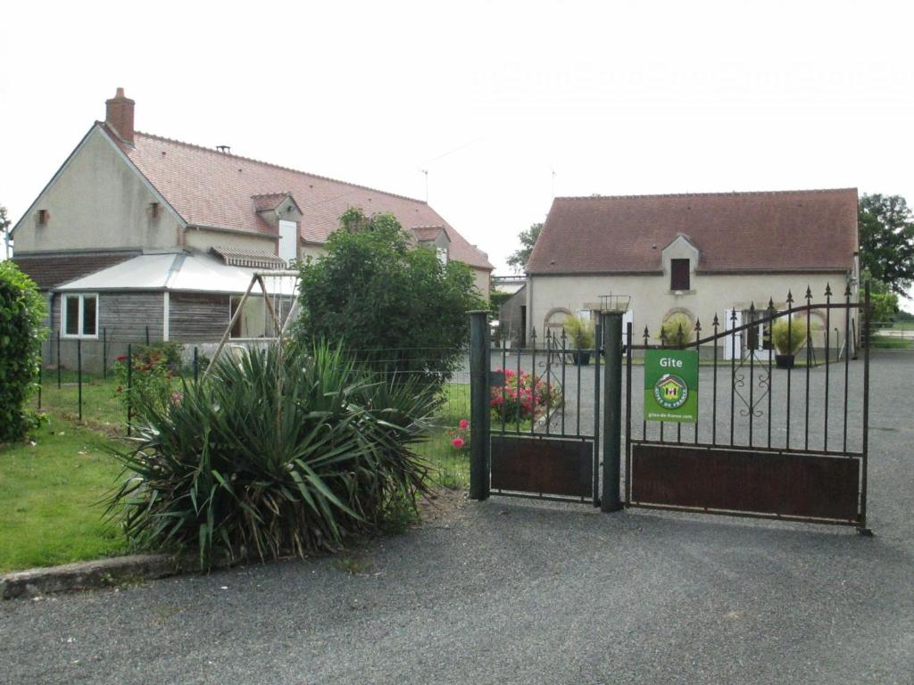 una puerta frente a una casa con jardín en Gîte Vieilles-Maisons-sur-Joudry, 5 pièces, 7 personnes - FR-1-590-89, en Vieilles-Maisons-sur-Joudry