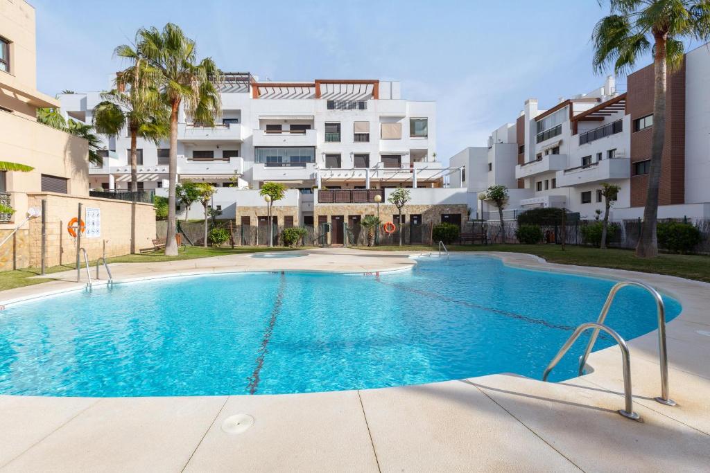 a swimming pool in front of a building at Penthouse La Cala De Mijas in La Cala de Mijas