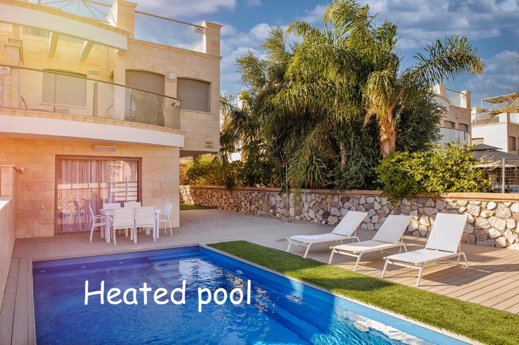 a house with a heated pool in front of a house at villa Debora with heated pool in Eilat
