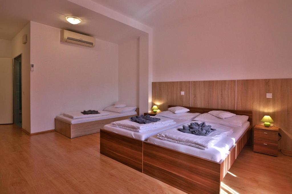 Postel nebo postele na pokoji v ubytování Margaréta Apartman és Üdülőház