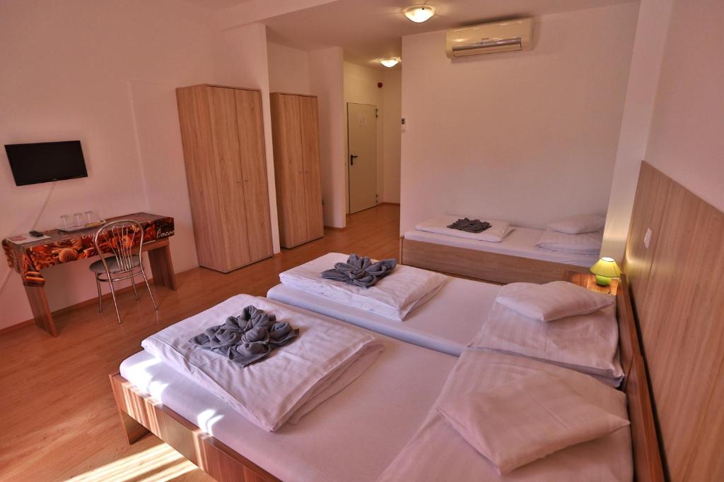 Postel nebo postele na pokoji v ubytování Margaréta Apartman és Üdülőház