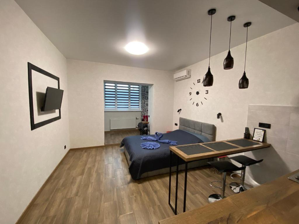 a bedroom with a bed and a table in it at Lightroom in Kharkiv