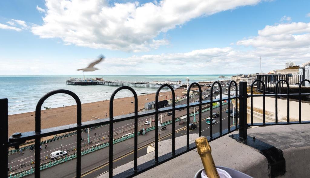 a bird flying over a beach and the ocean at Drakes Hotel in Brighton & Hove