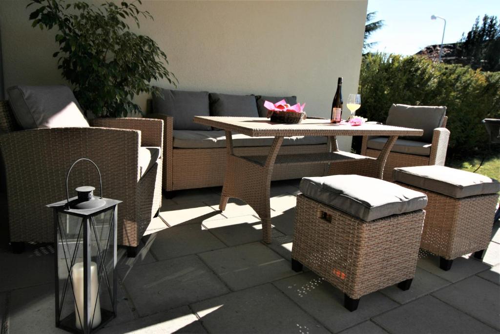 a patio with a table and chairs and a couch at Loreley Hills Residence 2 in Sankt Goarshausen