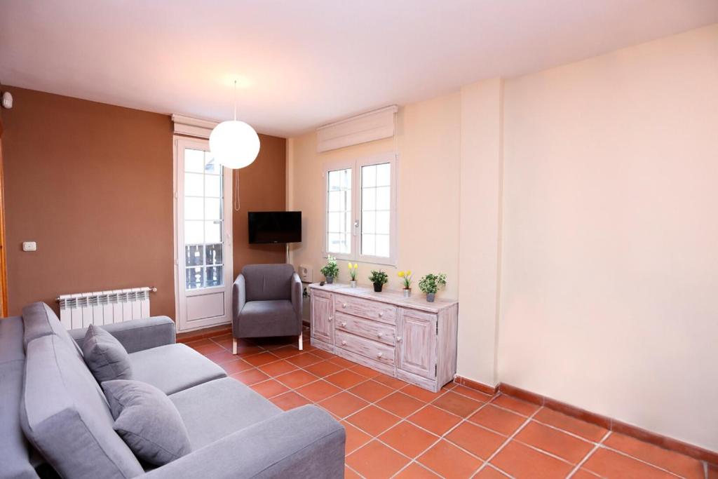 salon z kanapą i krzesłem w obiekcie Chalet Adosado zona med/baja w mieście Sierra Nevada