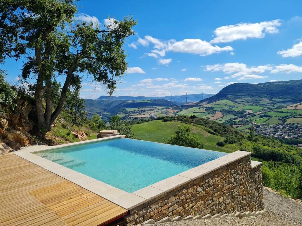 a swimming pool with a view of the mountains at Villa d'une chambre avec piscine privee jacuzzi et jardin amenage a Saint Georges de Luzencon in Saint-Georges-de-Luzençon