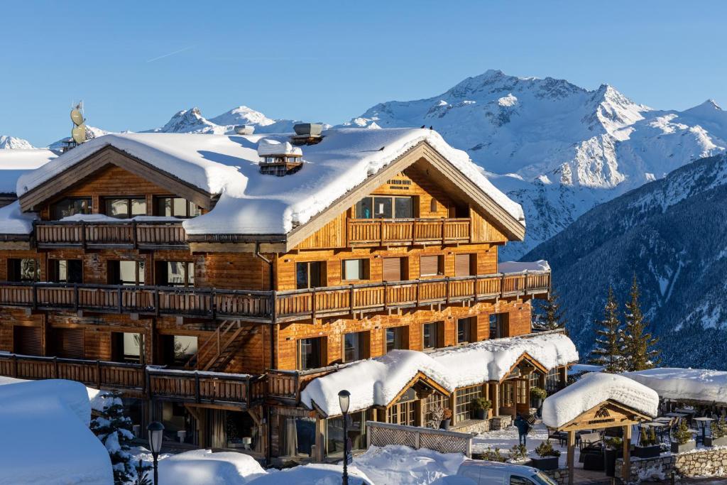 a large wooden building covered in snow at Grand Hôtel Courchevel 1850 in Courchevel