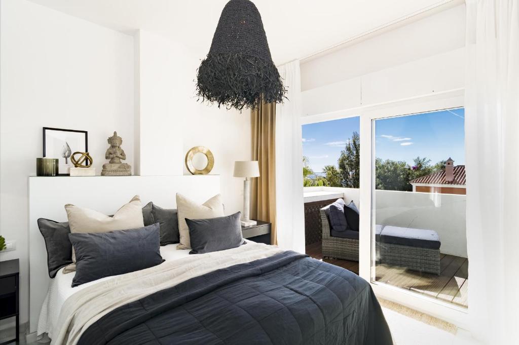 a bedroom with a bed and a large window at CL- 1 bedroom walking distance to Puerto Banus in Marbella