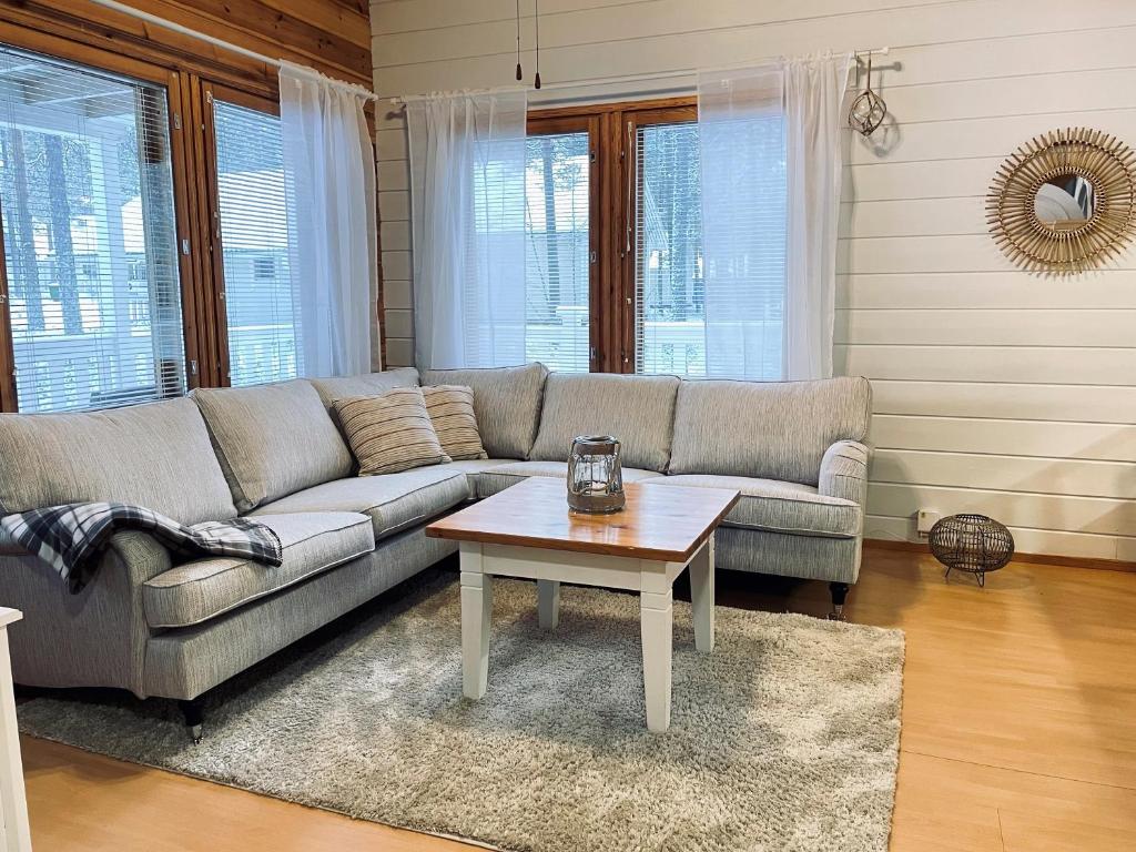 a living room with a couch and a coffee table at Lomasärkkä1 in Kalajoki