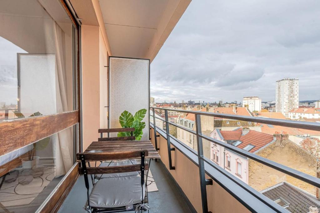 a balcony with a bench and a view of the city at L&#39;Horizon in Metz