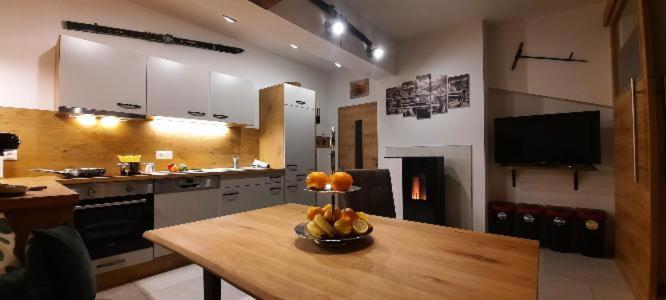 a kitchen with a table with a bowl of fruit on it at Haus Schober in Bad Hofgastein