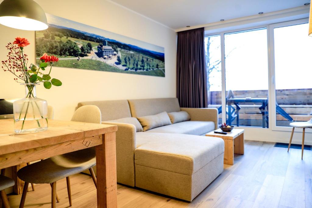 a living room with a couch and a table at Smart Resorts Haus Saphir Ferienwohnung 505 in Winterberg