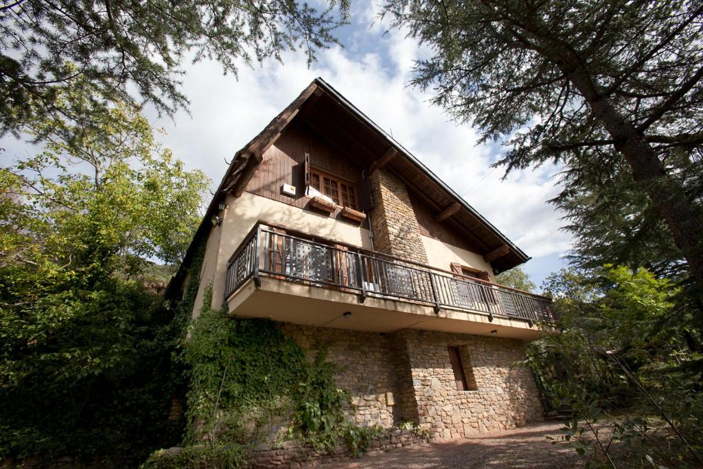 ein Gebäude mit einem Balkon auf der Seite in der Unterkunft La Caseta del bosc de Sort in Sort